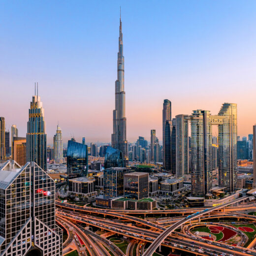 Aerial cityscape of Dubai at sunset with modern skyscrapers